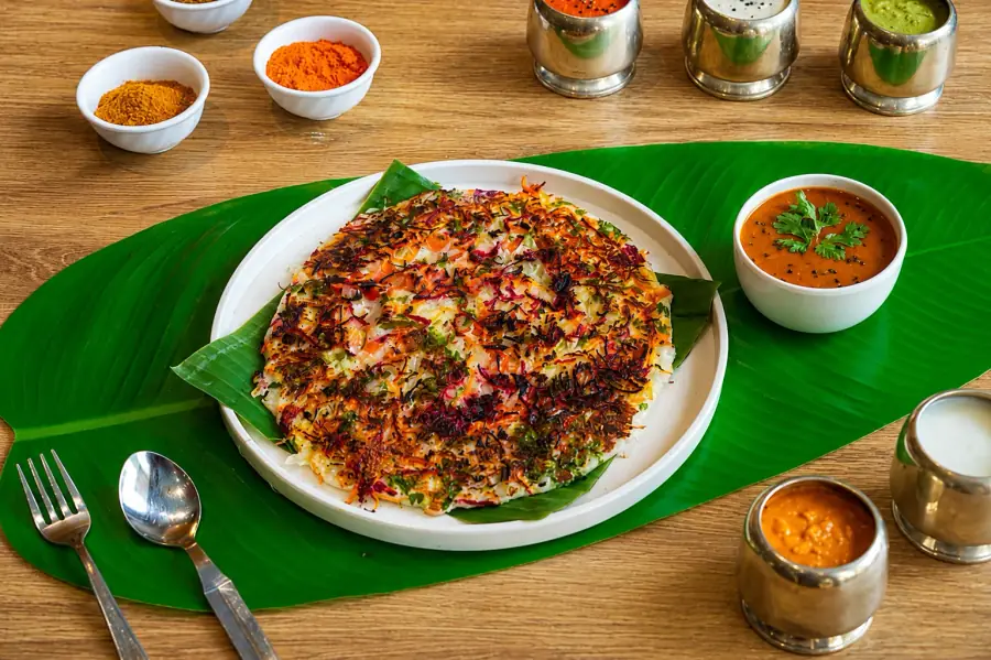 Colourful vegetable uttapam on a banana leaf