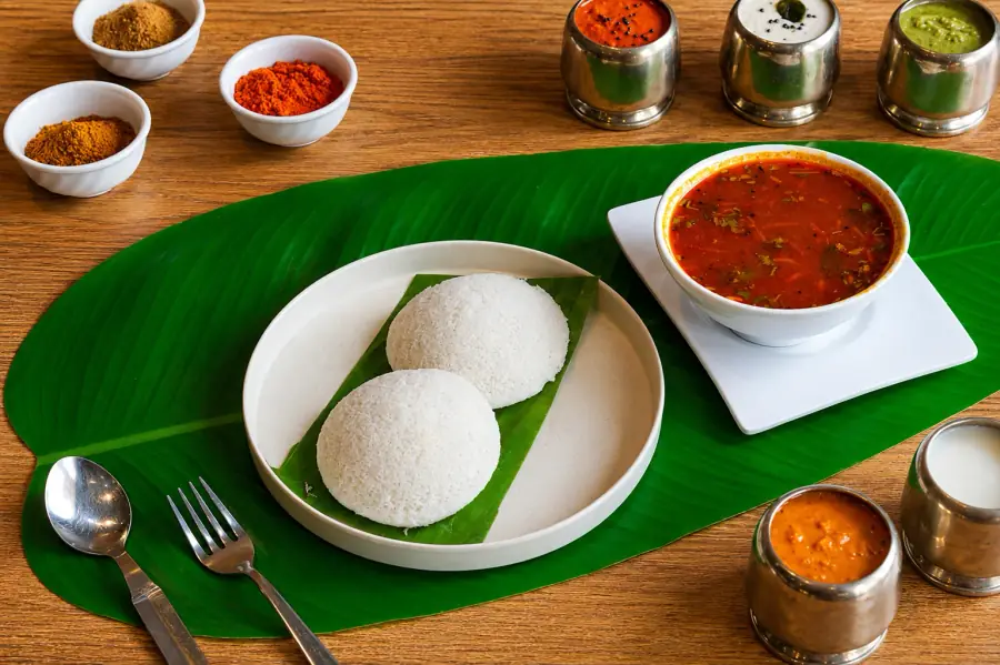 Soft idlis served with sambar and chutneys